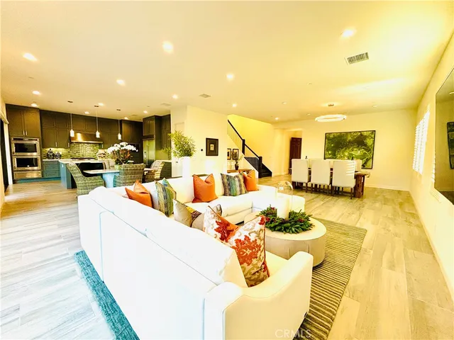 a dining room with furniture and wooden floor