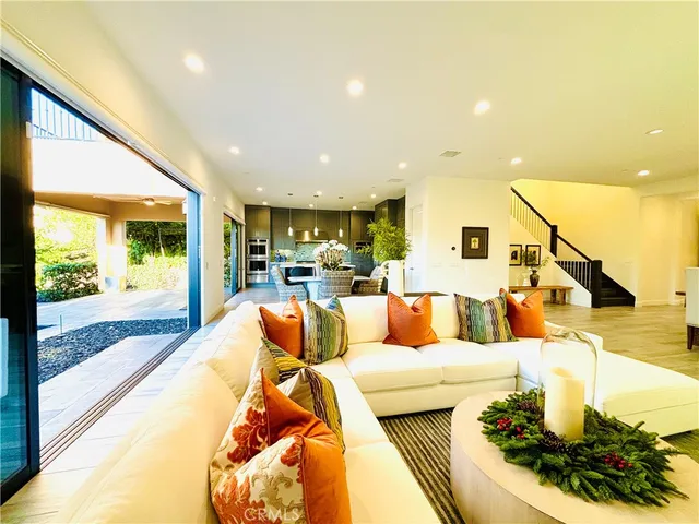 a front view of a house with a yard and potted plants