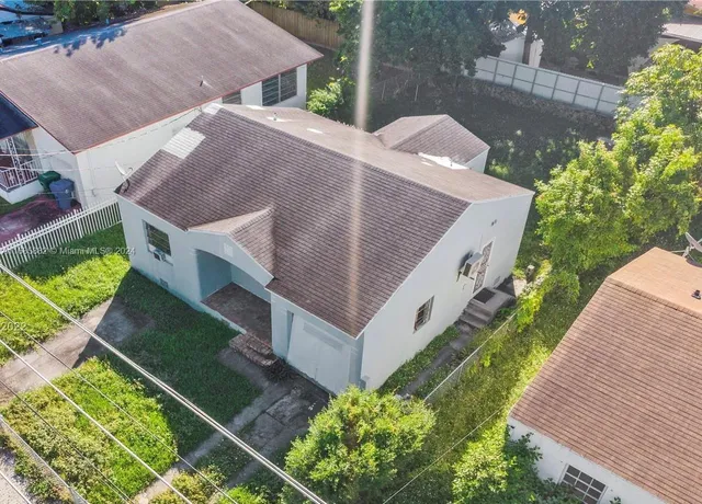 an aerial view of a house with a yard