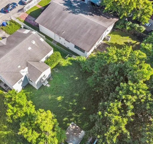 an aerial view of a house with a yard and garden