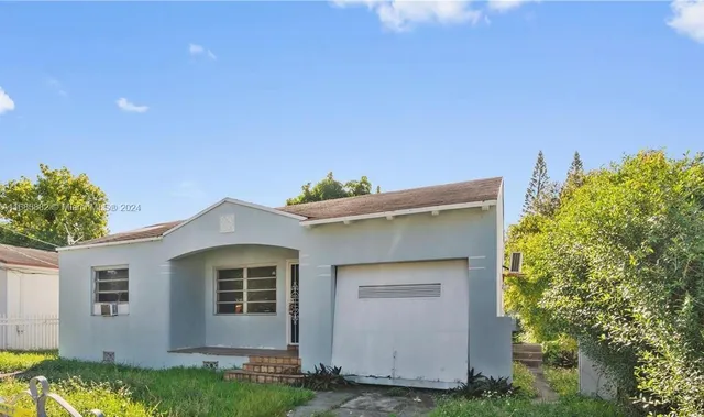 a view of house with yard