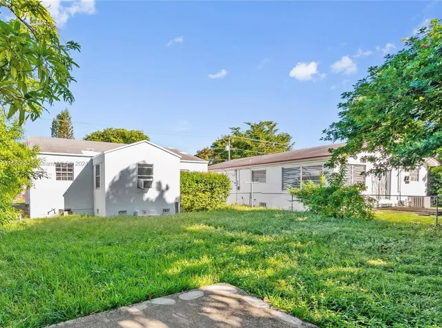 a view of a house with yard and a garden