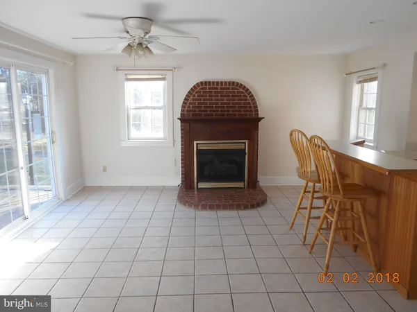a view of a livingroom with furniture and chandelier fan