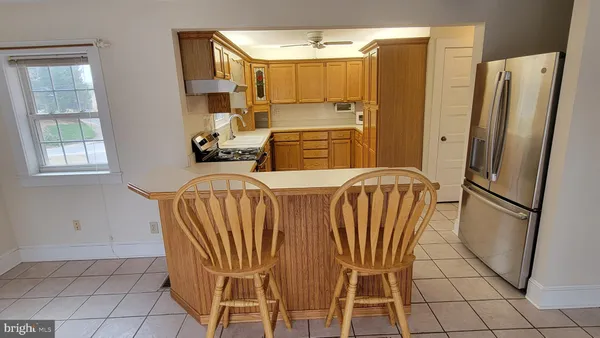 a kitchen with stainless steel appliances a refrigerator sink and cabinets