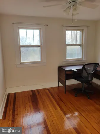 a room with a window and a wooden floor