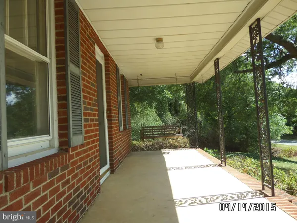 a view of a porch with a bench
