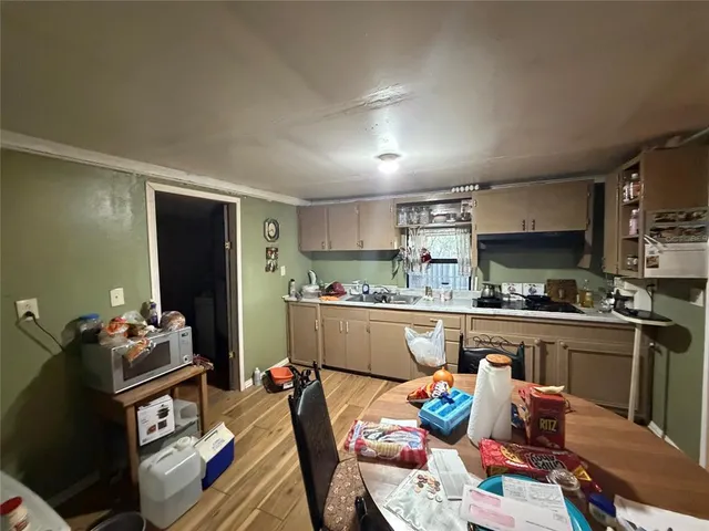 a kitchen with stainless steel appliances granite countertop a refrigerator and microwave