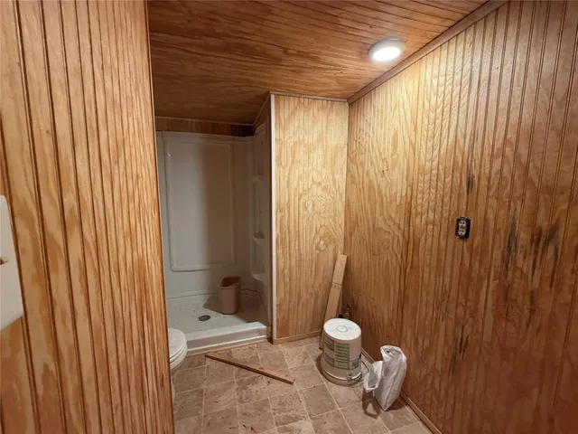a bathroom with a toilet a sink and shower curtain