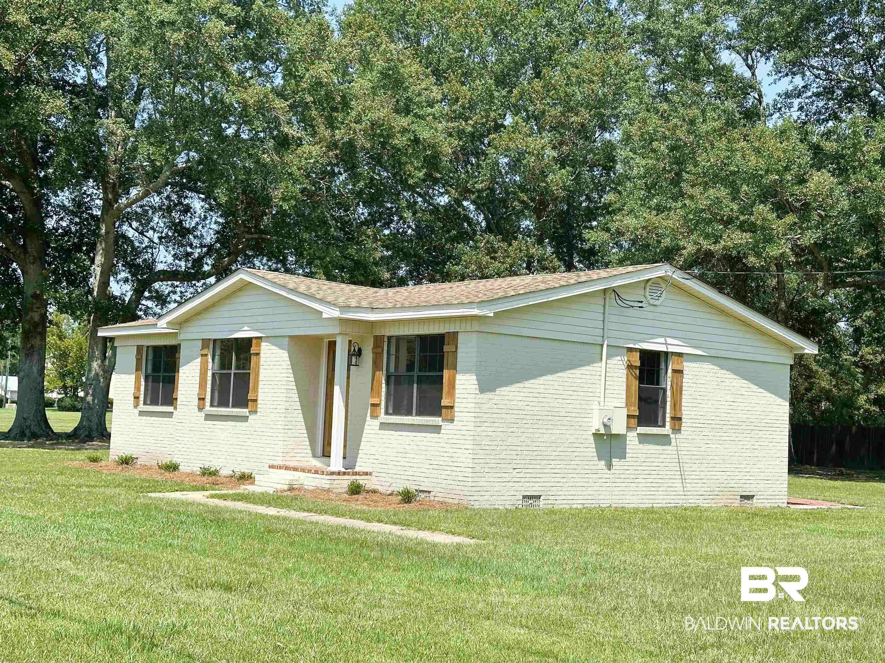 701 McRae Street Atmore, AL 36502 - Photo 11 of 11 Ranch-style home with crawl space, brick siding, a front yard, and roof with shingles