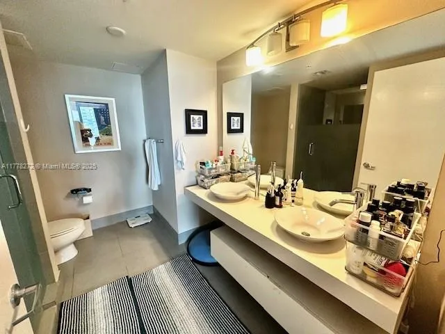 a bathroom with a sink double vanity and a mirror
