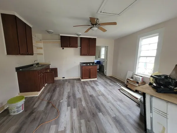 a kitchen with a wooden floor and stove top oven
