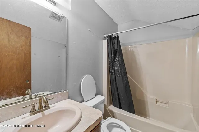 a view of a room with wooden floor and a ceiling fan