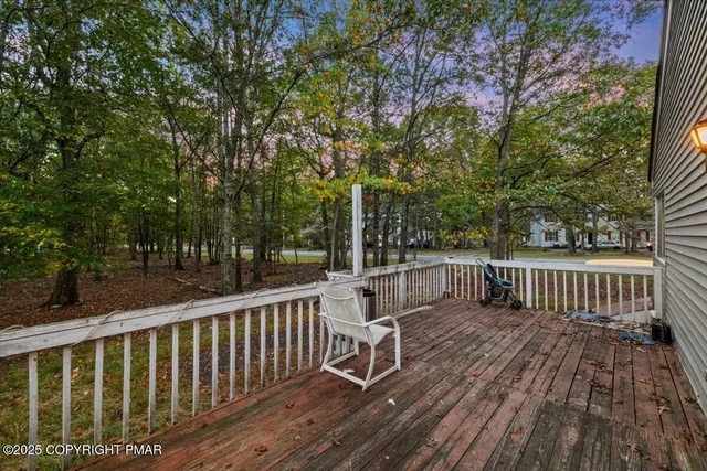 a view of balcony with wooden floor and fence