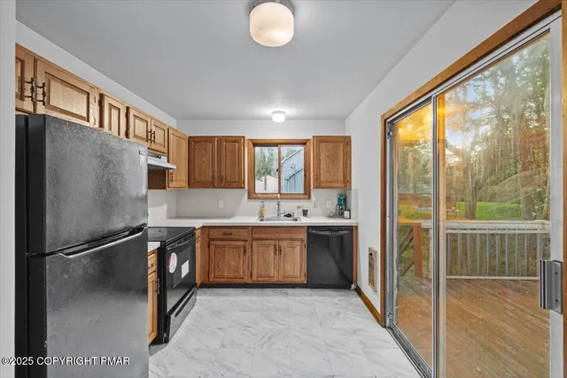 a kitchen with stainless steel appliances granite countertop a refrigerator and a sink