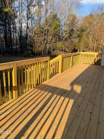 a view of balcony with wooden floor and fence