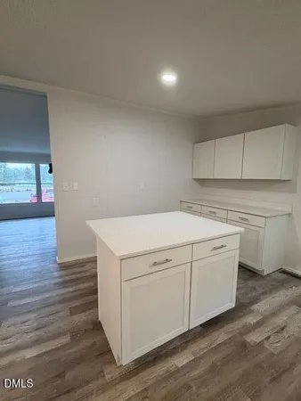 a utility room with cabinets washer and dryer