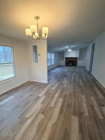 a room with kitchen island a wooden floor and a window