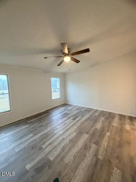 1185 Diamond Hills Road Stem, NC 27581 - Photo 8 of 14 an empty room with wooden floor and windows