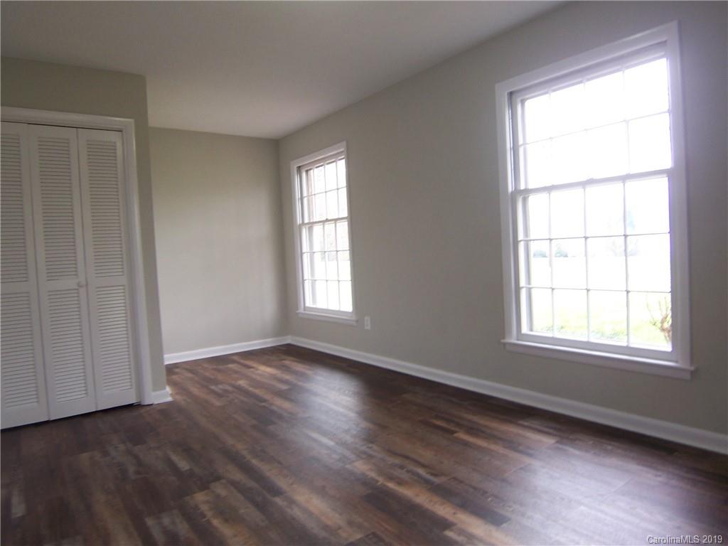 3804 Fallston Road Shelby, NC 28150 - Photo 15 of 24 a view of an empty room with wooden floor and a window