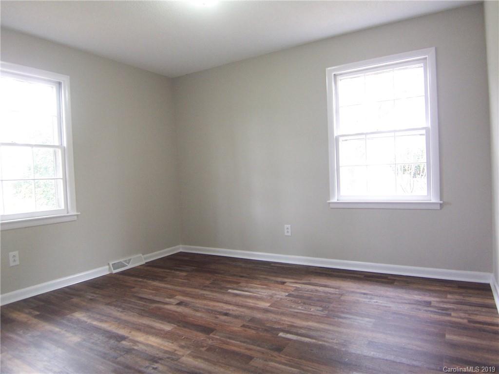 3804 Fallston Road Shelby, NC 28150 - Photo 16 of 24 an empty room with wooden floor and windows