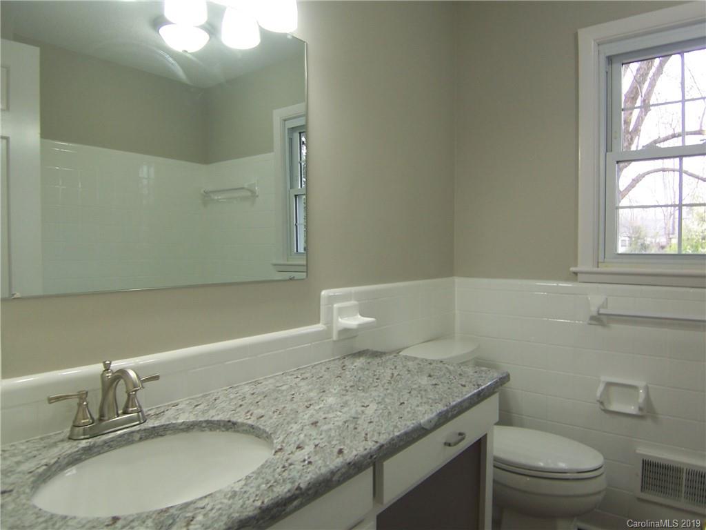 3804 Fallston Road Shelby, NC 28150 - Photo 17 of 24 a bathroom with a granite countertop sink a toilet and a mirror