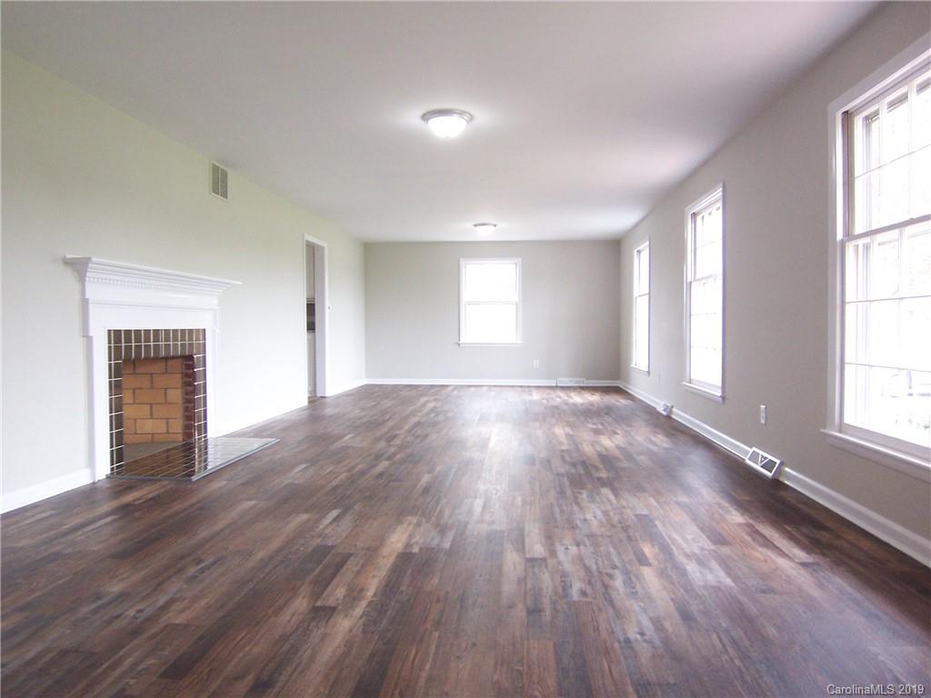 3804 Fallston Road Shelby, NC 28150 - Photo 4 of 24 an empty room with wooden floor and windows
