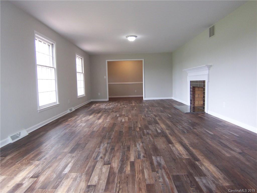 3804 Fallston Road Shelby, NC 28150 - Photo 5 of 24 an empty room with wooden floor and windows