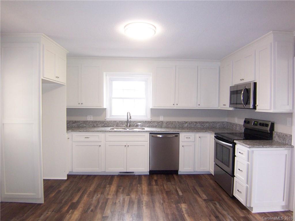 3804 Fallston Road Shelby, NC 28150 - Photo 8 of 24 a kitchen with granite countertop white cabinets sink and appliances