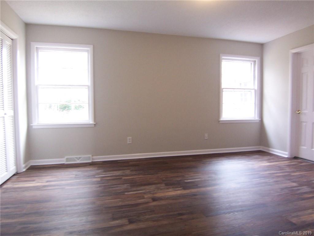 3804 Fallston Road Shelby, NC 28150 - Photo 10 of 24 an empty room with wooden floor and windows