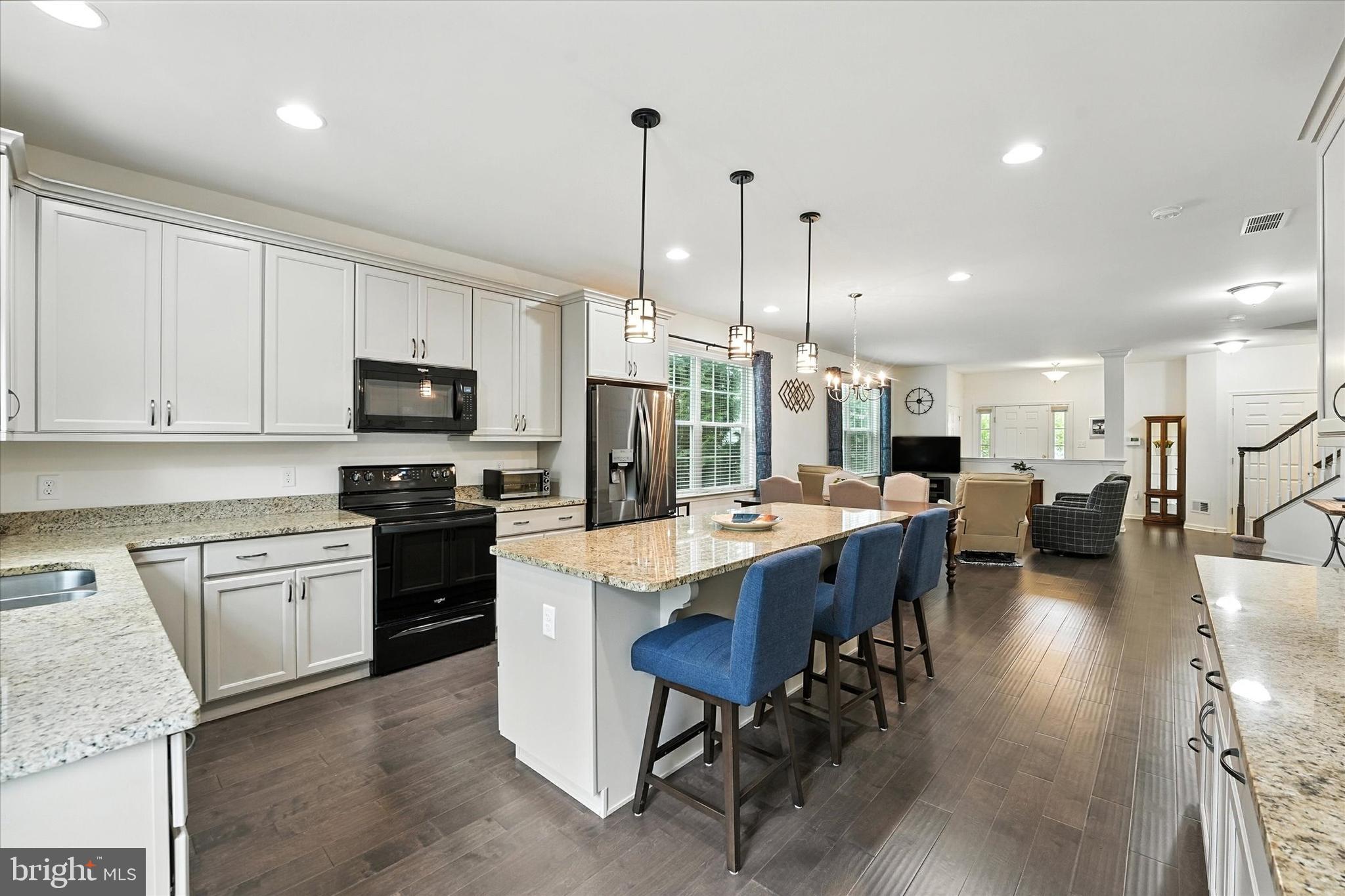 167 Sirius Drive Bear, DE 19701 - Photo 1 of 47 a large kitchen with kitchen island granite countertop lots of white cabinets appliances and furniture