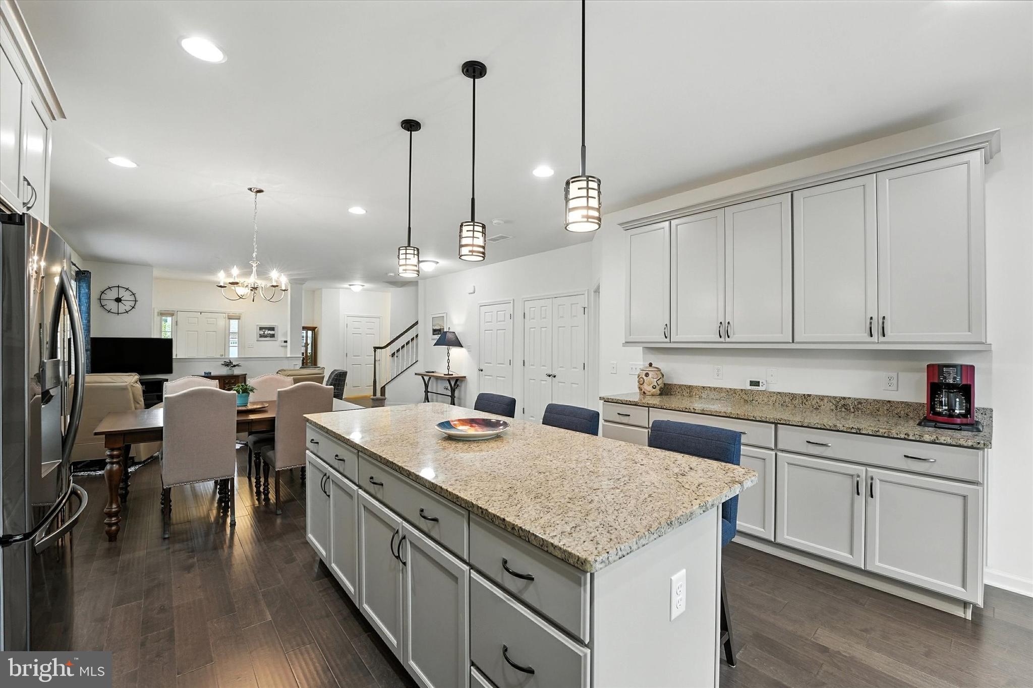 167 Sirius Drive Bear, DE 19701 - Photo 12 of 47 a large kitchen with kitchen island a sink a center island a stove and a center island