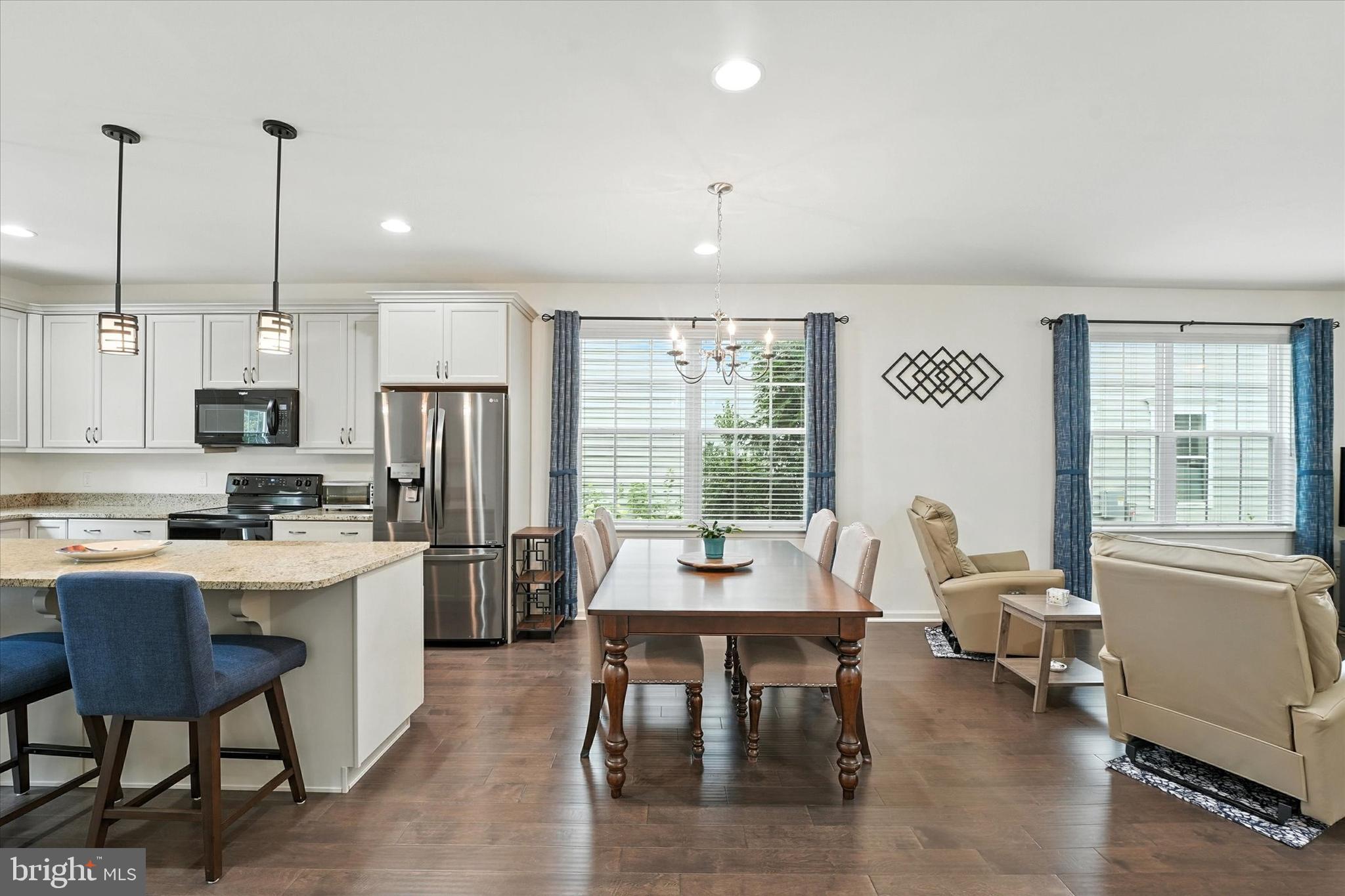 167 Sirius Drive Bear, DE 19701 - Photo 10 of 47 a living room with stainless steel appliances furniture a dining table and chairs