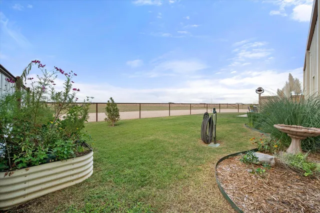 a view of a chairs and table in patio