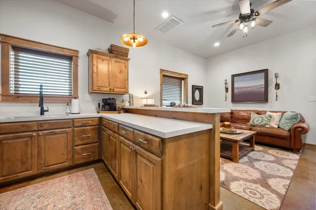 a kitchen with a sink appliances cabinets and a window