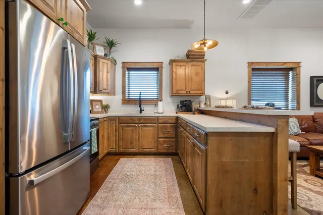a kitchen with stainless steel appliances granite countertop a sink a stove and microwave