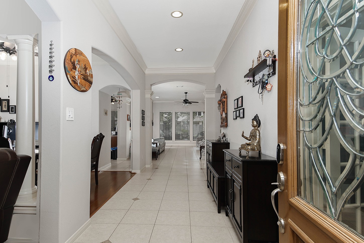 18722 Duke Lake Drive Spring, TX 77388 - Photo 3 of 26 a hallway with painting on the wall and a large mirror