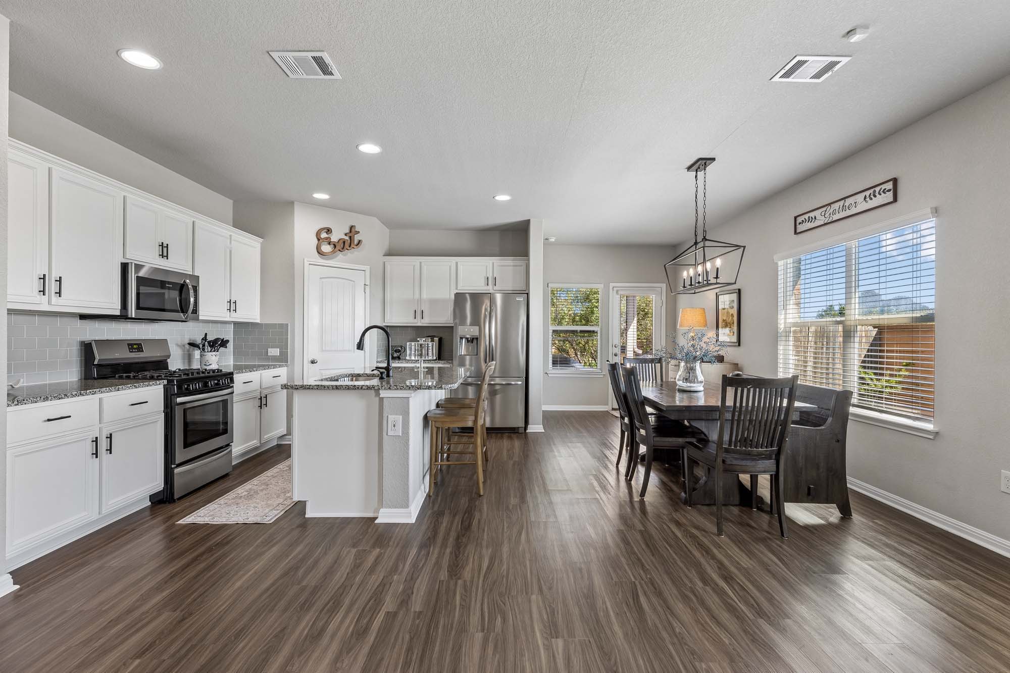 124 Moravia Road Georgetown, TX 78626 - Photo 7 of 38 Gleaming wood floors anchor an airy, open layout with seamless transition between spaces.