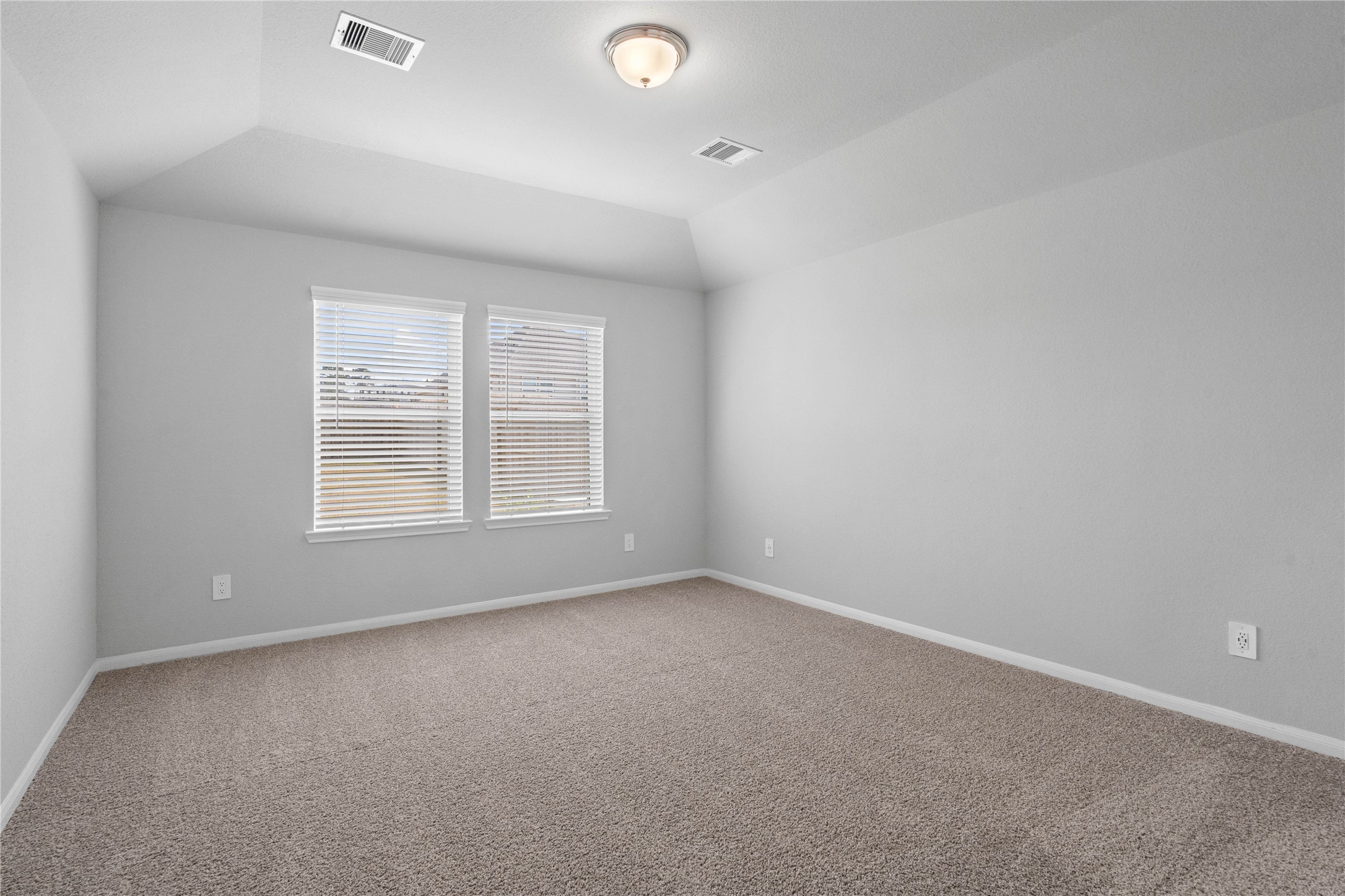 19645 Montgomery Rdg Way Montgomery, TX 77316 - Photo 27 of 41 The primary bedroom provides a peaceful escape with a bright, neutral palette, sloped ceilings, large windows, and plush carpet flooring, creating a calm and restorative atmosphere to end your day.