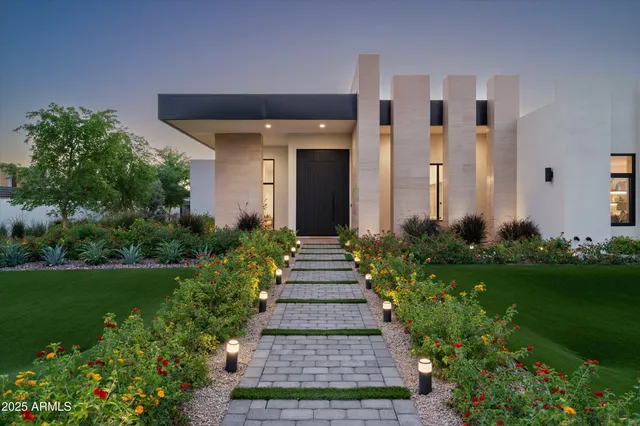 a front view of a house with garden