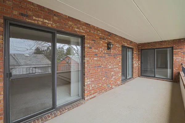 a view of a brick house with a large window