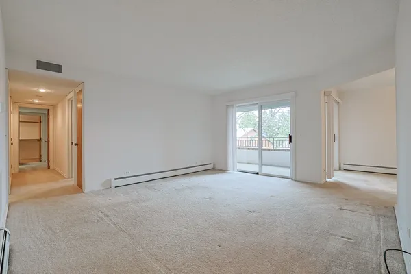 an empty room with windows and closet