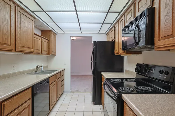 a kitchen with stainless steel appliances granite countertop a stove and a refrigerator