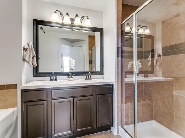 a bathroom with a double vanity sink and a mirror