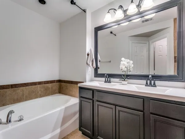a bathroom with a bathtub and a mirror