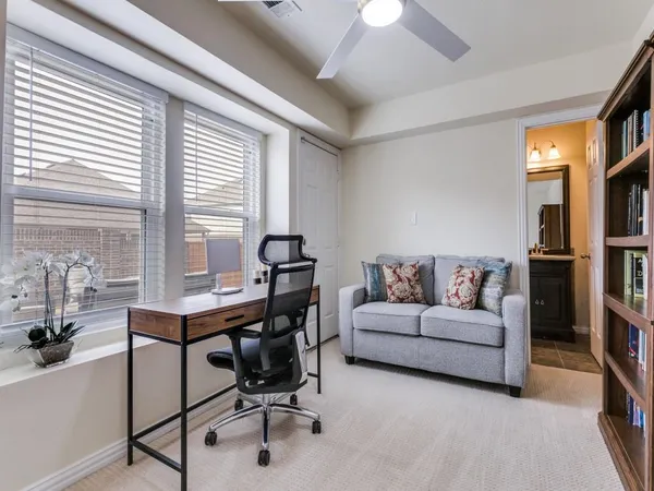 a living room with furniture a table and a large window