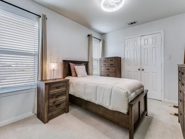 a bedroom with a bed and dresser