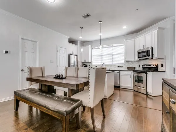 a kitchen with stainless steel appliances kitchen island granite countertop a stove a sink a refrigerator and a microwave