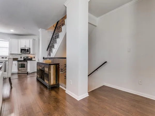 a view of a kitchen with furniture and wooden floor