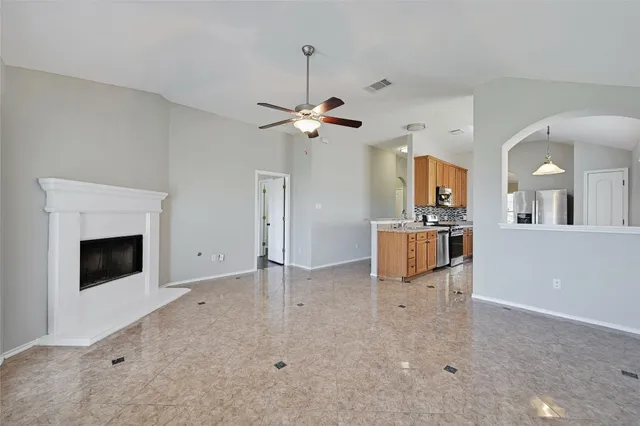 a view of a kitchen with a sink and a fireplace