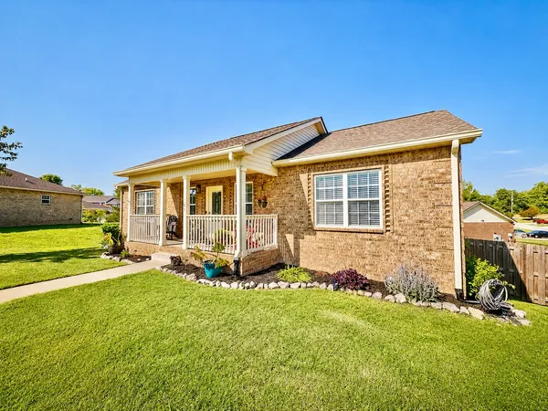 a view of a house with a backyard